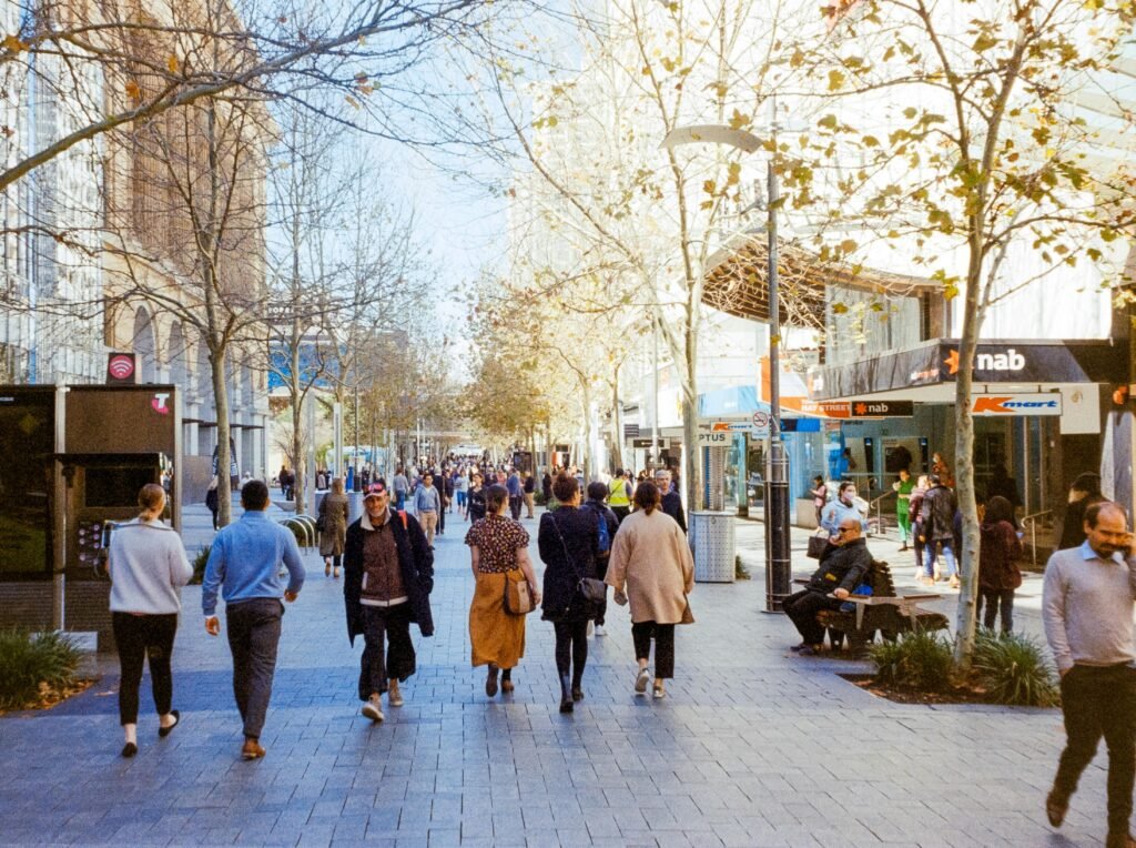 Crowds walking down a busy city street in Perth, Australia, during the day.